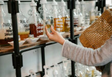 Woman Looking at Shampoo With Plant Extracts