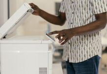 Staff Member Using Fax Machine