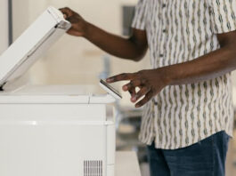 Staff Member Using Fax Machine