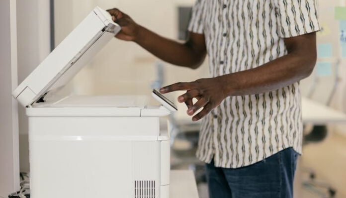 Staff Member Using Fax Machine